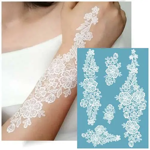 Motif de tatouage éphémère dentelle fine avec petites fleurs blanches, idéal pour les mariages ou les occasions estivales.